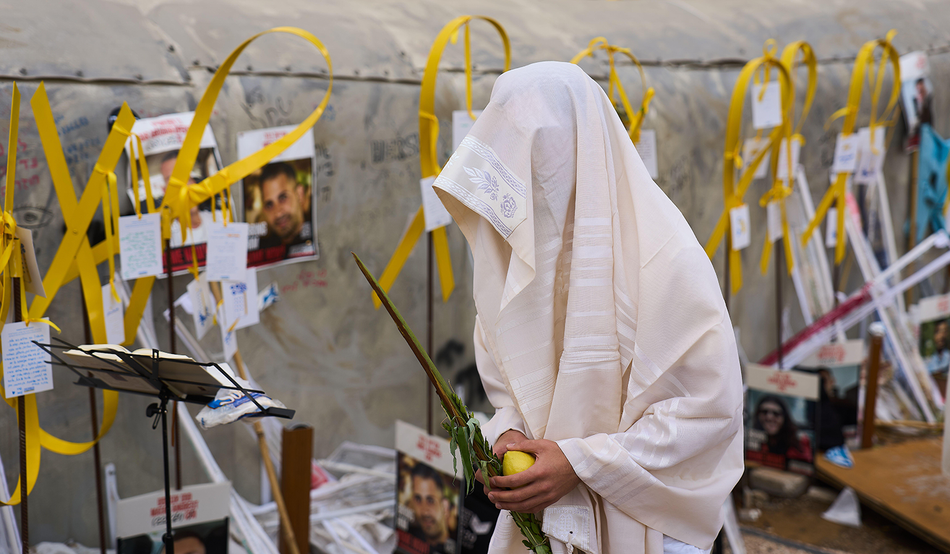 A man prays at Hostages Square, Tel Aviv following the announcement that Israel and Hamas have agreed to the first phase of a peace plan, 10th October 2025. Image by Associated Press / Ariel Schalit / Alamy