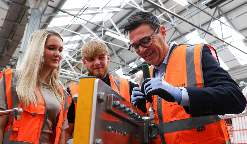 Andy Burnham, right, visits Alstom in Derby, on the day he unveils new technical educational routes aimed at tackling youth unemployment. Image: AP / Alamy