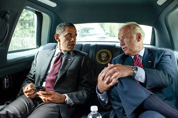 President Barack Obama and Vice President Joe Biden walk ride together in the motorcade from the White House to the Ronald Reagan Building to sign the Dodd-Frank Wall Street Reform and Consumer Protection Act, July 21, 2010.  (Official White House Photo b