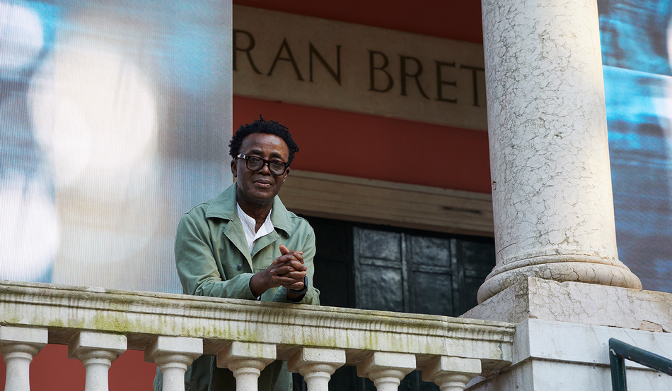 Paying attention: Akomfrah with his installation for the British Pavilion in Venice. Image: Jack Hems