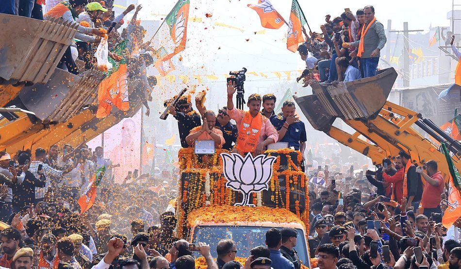 Yogi Adityanath (shown with his hands in a prayer position) takes part in a bulldozer-themed election roadshow in Jaipur, in November 2023. Image: Ishal Bhatnagar/NurPhoto via Getty Images