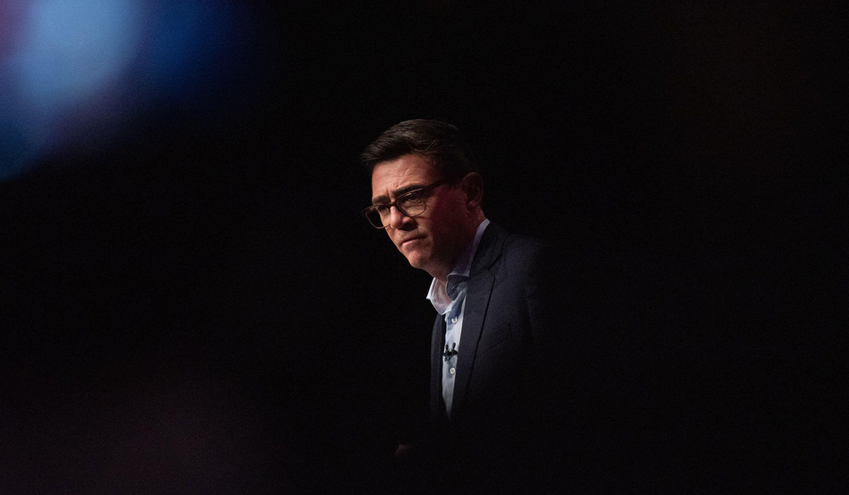 Andy Burnham, wearing a suit and looking serious, set against a black background.  Image: Alamy/Will Colebourne
