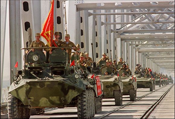 A convoy of Soviet Army armoured personal vehicles cross a bridge in Termez, 21 May 1988 at Soviet-Afghan border, during the withdrawal of the Red Army from Afghanistan. The Soviet Union invaded Afghanistan in December 1979 to shore up the pro-Soviet regi