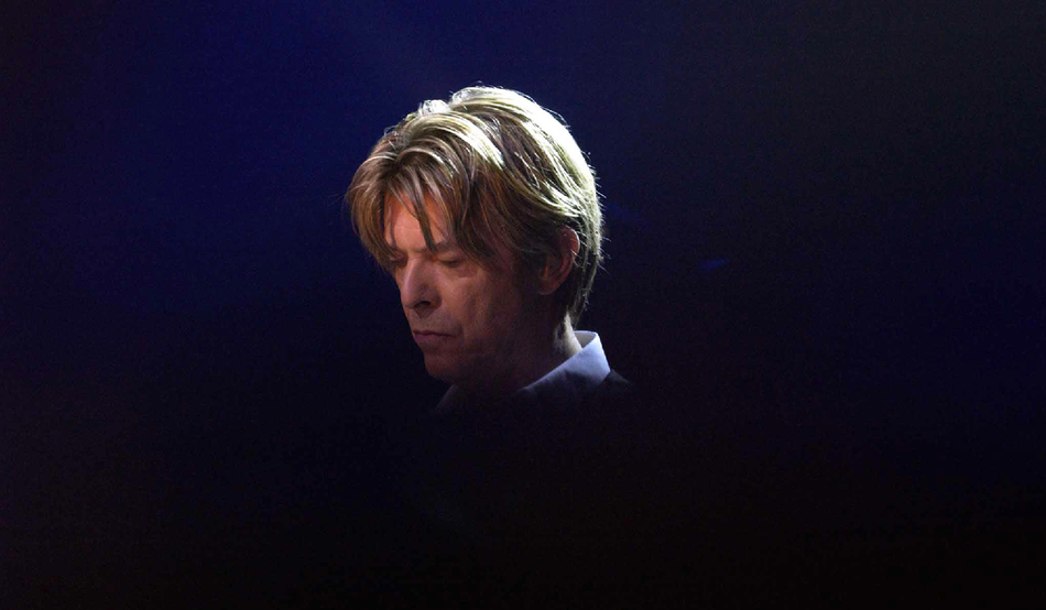 From the shadows: David Bowie performs at London’s Royal Festival Hall in 2002. Image: Image: William Conran / PA Images / Alamy