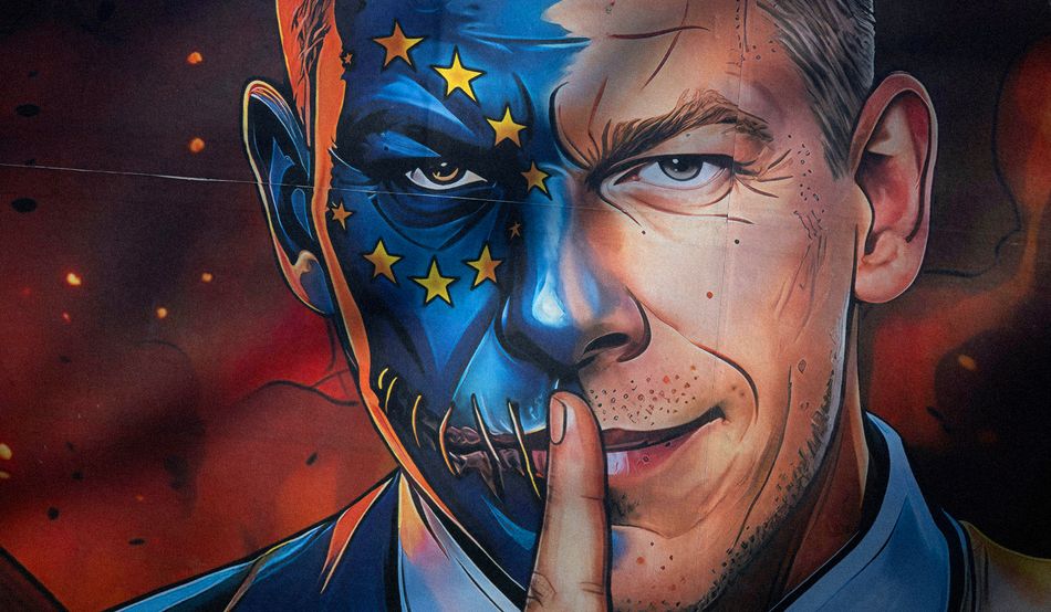 A Fidesz election campaign poster showing Péter Magyar, Hungary’s new prime minister, as a two-faced man with half his face transformed into the EU flag. Image: Alamy 