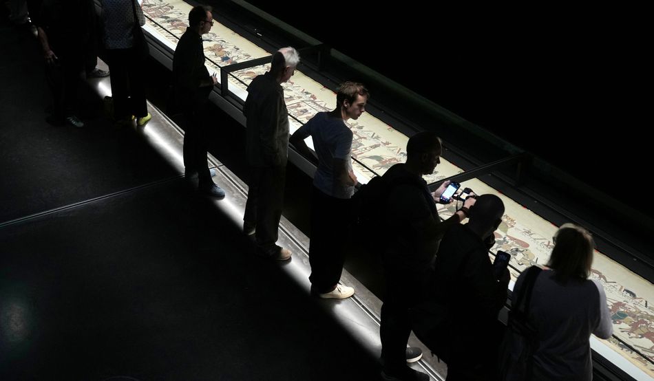 Vistors to the British Museum try to make sense of the Tapestry. Image: Alamy