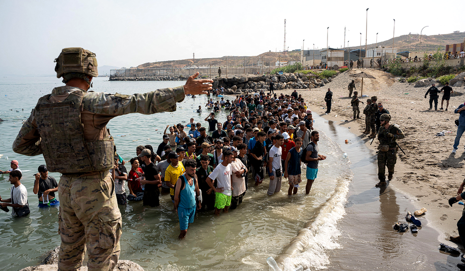 Migrants gather near the border crossing between Morocco and the Spanish enclave of Ceuta, 31st July. Photo by Alamy / Mario Moron / JNA Press.
