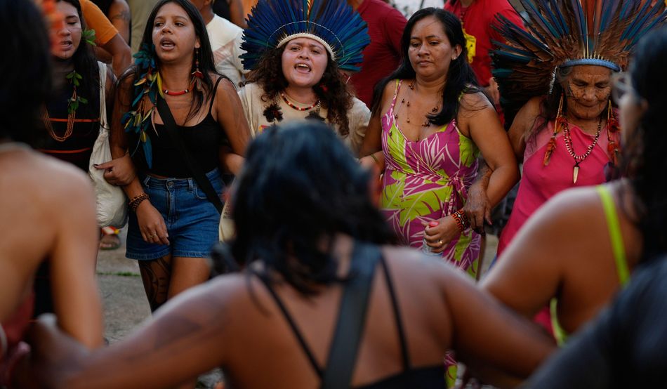 Indigenous peoples sing and dance as they participate in an opening ceremony as part of the People’s Summit in Belem, Brazil. Image: Associated Press/Alamy
