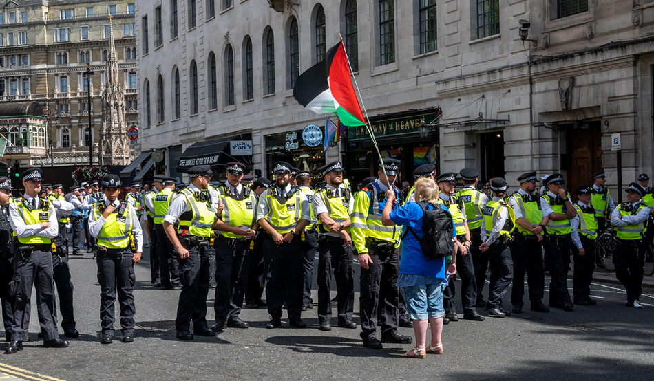 Police gathered at a protest against proscribing Palestine Action, June 2025. Image by Maggie Sully / Alamy
