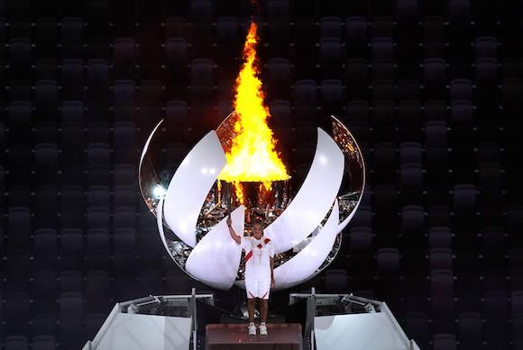 Japan's Naomi Osaka lights the Olympic flame at the opening ceremony of Tokyo 2020. Credit: Alamy