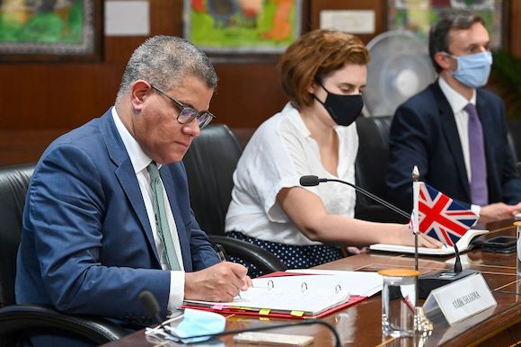 UN Climate Change Conference or COP26 President Alok Sharma (L) takes notes while listening to India Minister of Environment, Forest and Climate Change Bhupender Yadav during a meeting in New Delhi on August 18, 2021 during his three-day visit to India fo