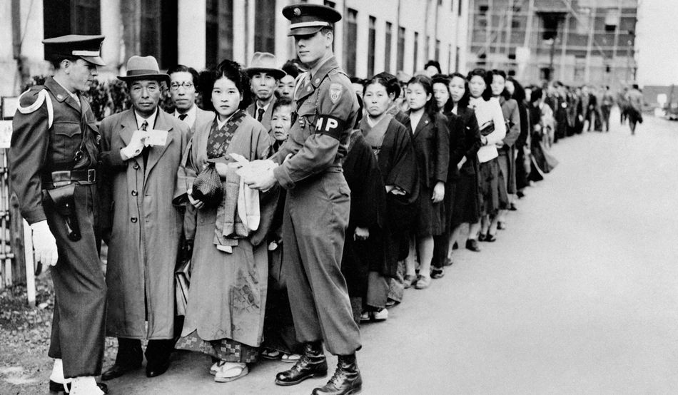 Gripping the nation: Japanese people queuing outside the war crimes tribunal in 1946 © Science History Images / Alamy