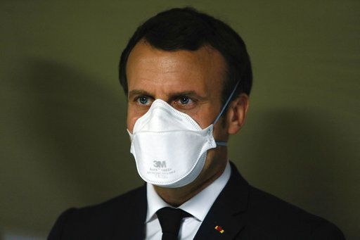 French President Emmanuel Macron wearing face masks during the visit of the military field hospital outside the Emile Muller Hospital in Mulhouse, eastern France, on March 25, 2020, on the tenth day of a strict lockdown in France to stop the spread of COV