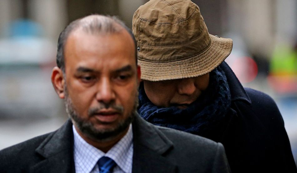 Lutfur Rahman, right, walks into the High Court behind aides on 25th February 2015 © Dan Kitwood/Getty Images