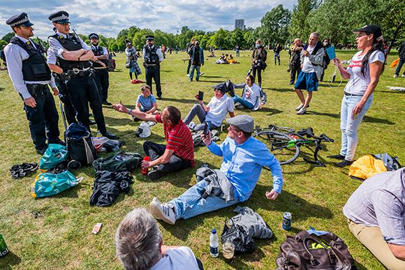 Longer arm of the law: police disrupt a park gathering during lockdown © Guy Bell/Shutterstock