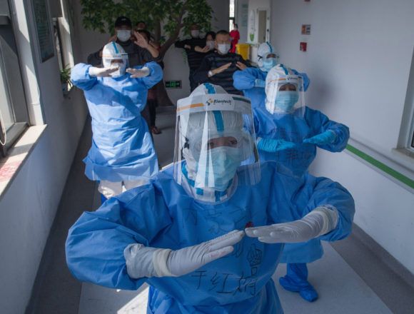 Medical workers in Wuhan leading patients in practising traditional Chinese aerobics. Photo: Shutterstock