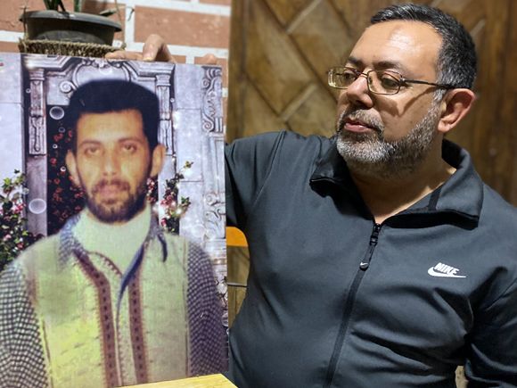 Mohammed Sadeq Faraj holds a picture of his brother Alaa, who was kidnapped in 2007 and has never been found