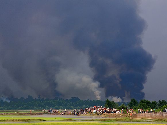 MANDRU, MYANMAR - 2017/06/09: Rohingayas houses are burning  by Myanmar army. Thousands of Rohingyas still crossing the border between Myanmar and Bangladesh after the Burmese army started an operation against the Rohingyas, by burning and destroying thei