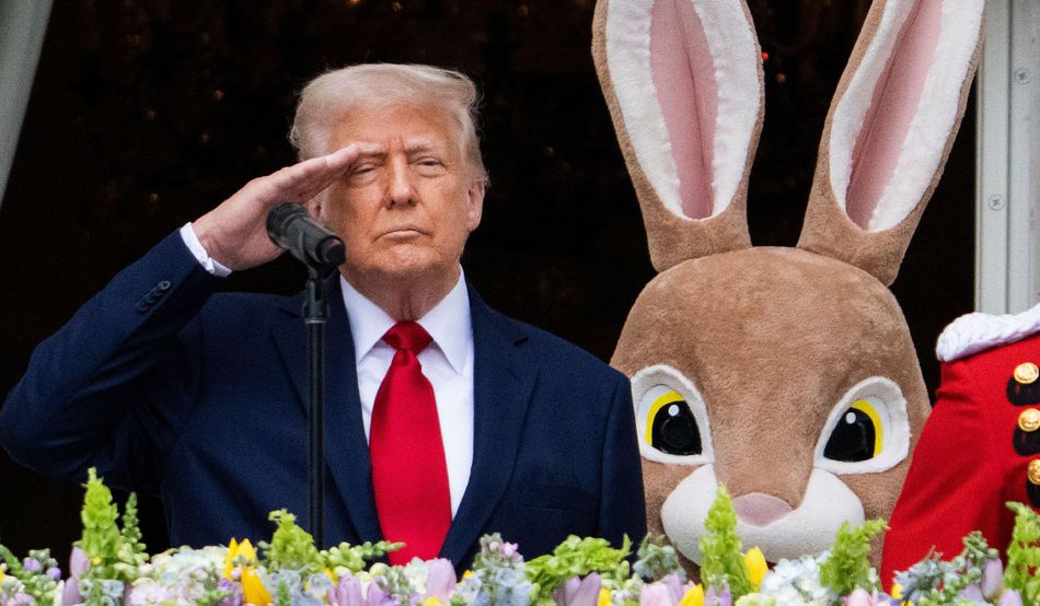 Donald Trump salutes from the White House balcony. A person in a giant Easter Bunny costume looms behind him. Image: Prospect