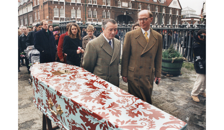 Gilbert & George beside their friend Joshua Compston’s coffin outside Christchurch Spitalfields in 1996. Image: Kippa Matthews
