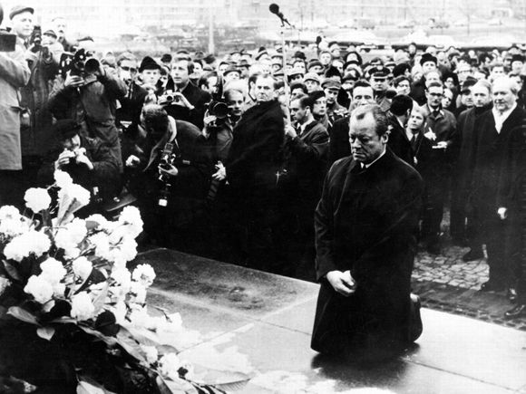 In memory of memory: West German chancellor Willy Brandt kneels before  a monument in the former Jewish ghetto of Warsaw in 1970