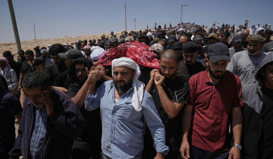 Mourners carry the body of Awdah Hathaleen during his funeral in Umm al-Khair last August. Image: AP / Alamy
