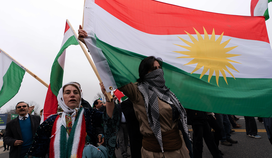 Supporters of Iranian democracy carry the Kurdish flag as they march in Washington on 7th March 2026. Credit: Associated Press/Alamy