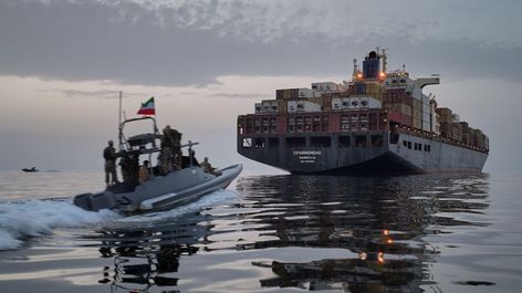 An Iranian IRGC speedboat approaching a cargo ship in the Strait of Hormuz in April. Image: Alamy